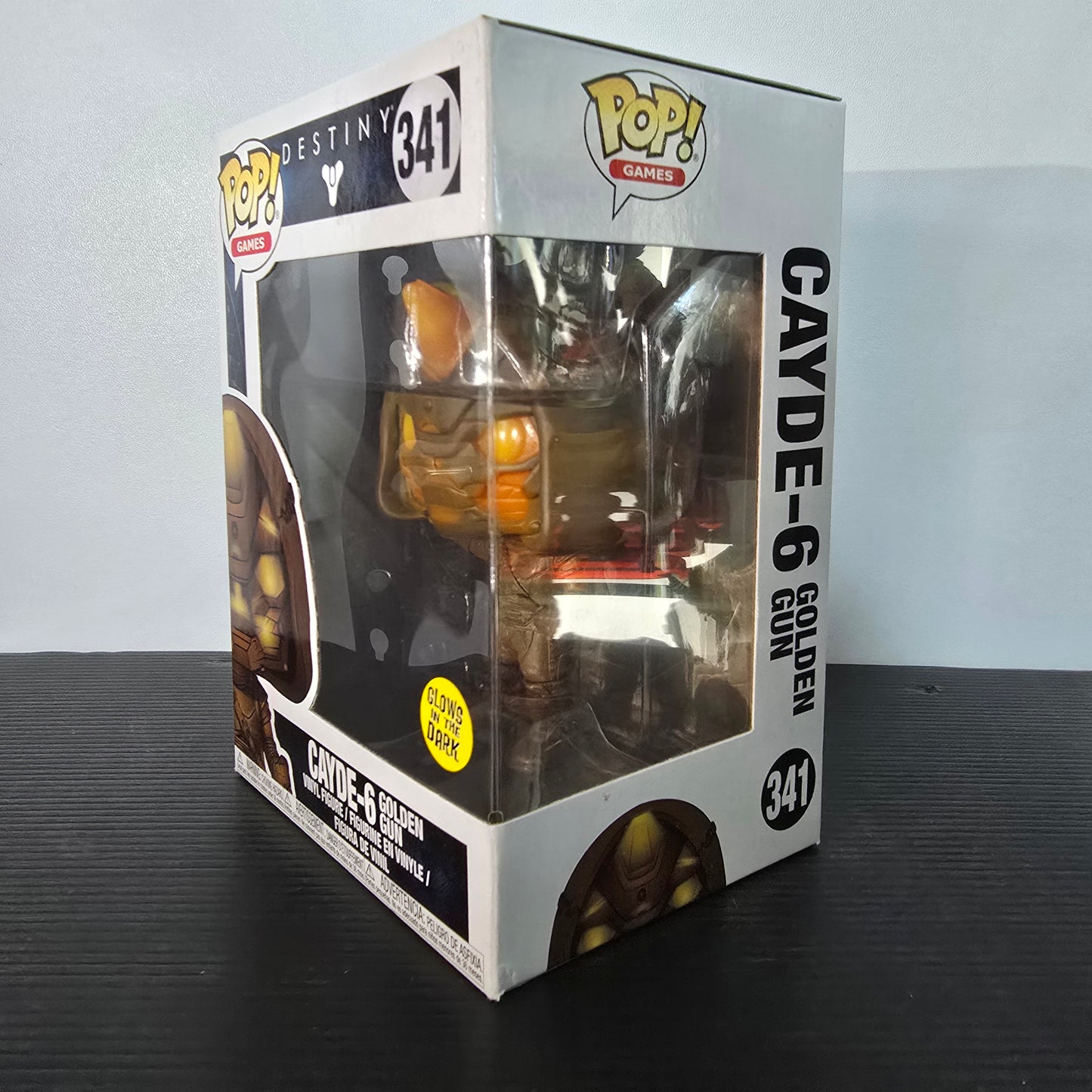 Funko Pop! Games Destiny Cayde-6 Golden Gun #341 vinyl figure, known for its "Glows in the Dark" feature.
